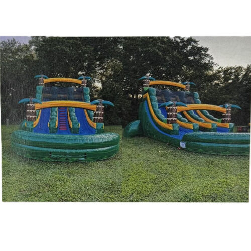 Colorful inflatable bounce slide on a grassy yard beside a brick house under a cloudy sky