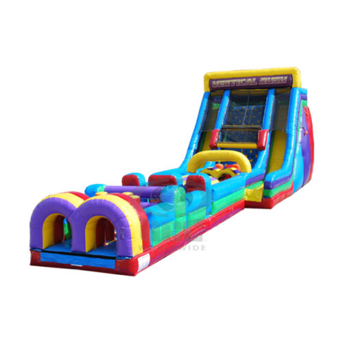 Colorful inflatable bounce slide on a grassy yard beside a brick house under a cloudy sky