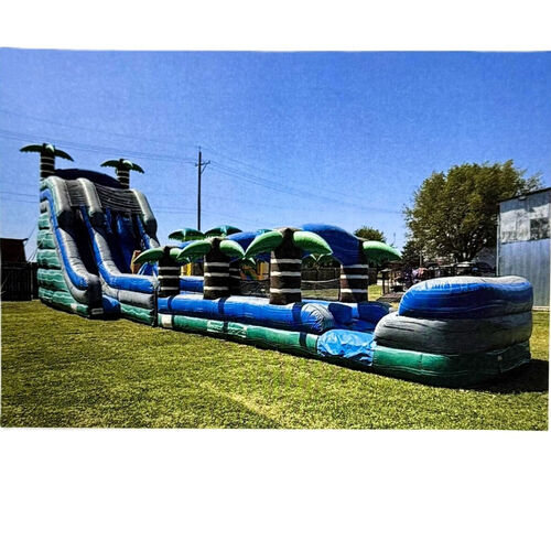 Colorful inflatable bounce slide on a grassy yard beside a brick house under a cloudy sky