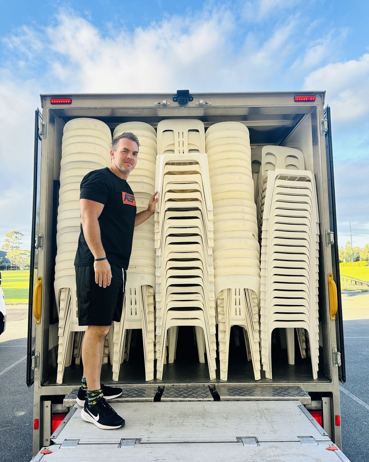Adept Hire truck loaded with white chairs ready for delivery in Brisbane